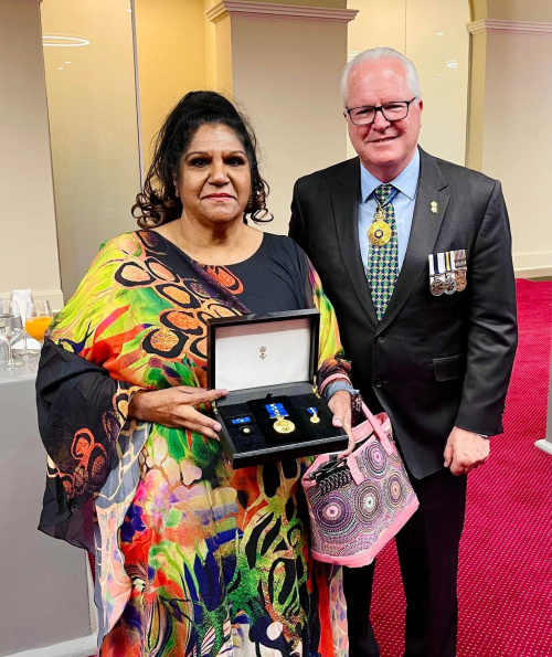 Govt official with Denise Smith-Ali, holding her OAM Award